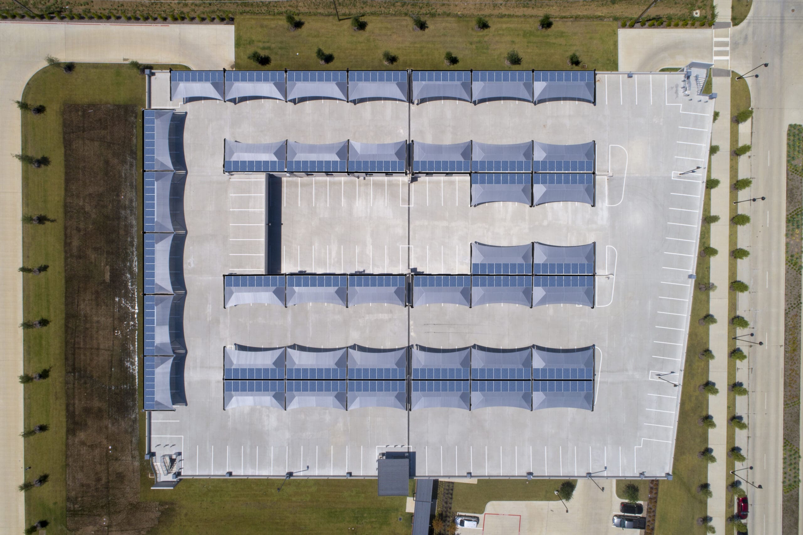 Rooftop parking with solar panels, overhead view