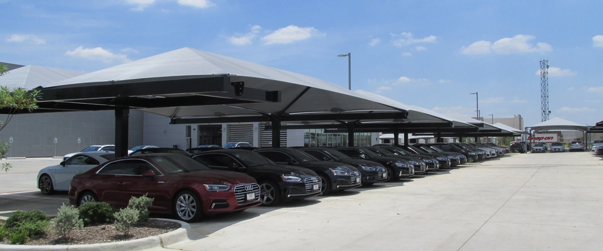 Cars parked under structure during the day thumbnail