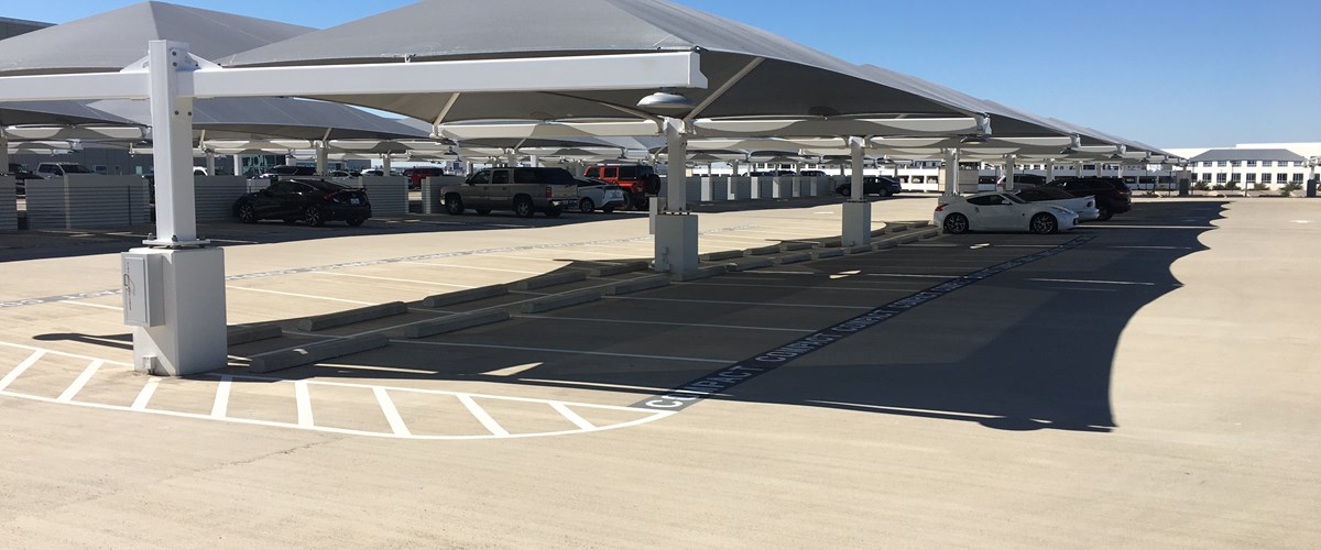 Parking lot with cars under shade structure thumbnail