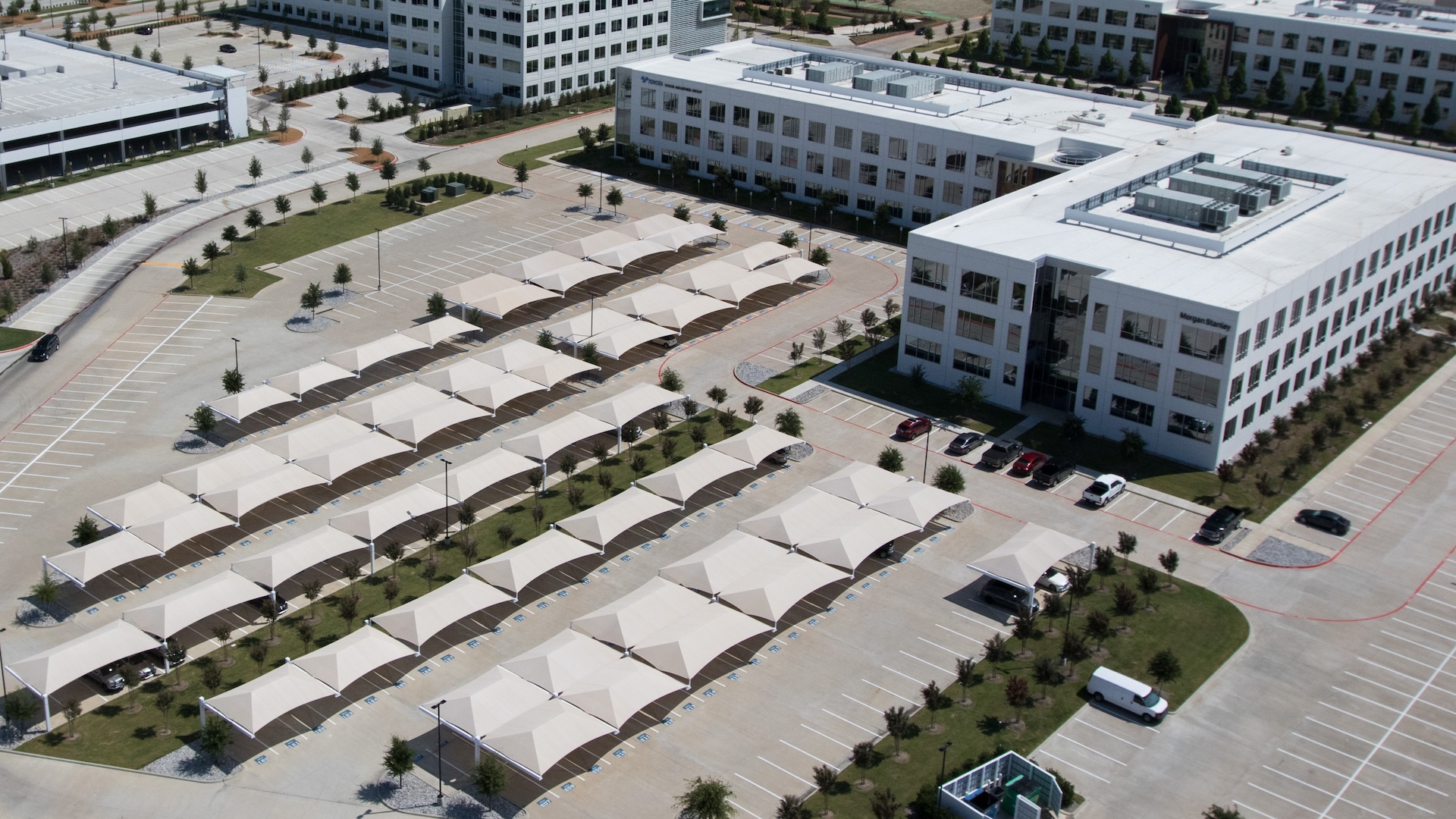 full cantilever joined structure providing shading and weather protection for parking